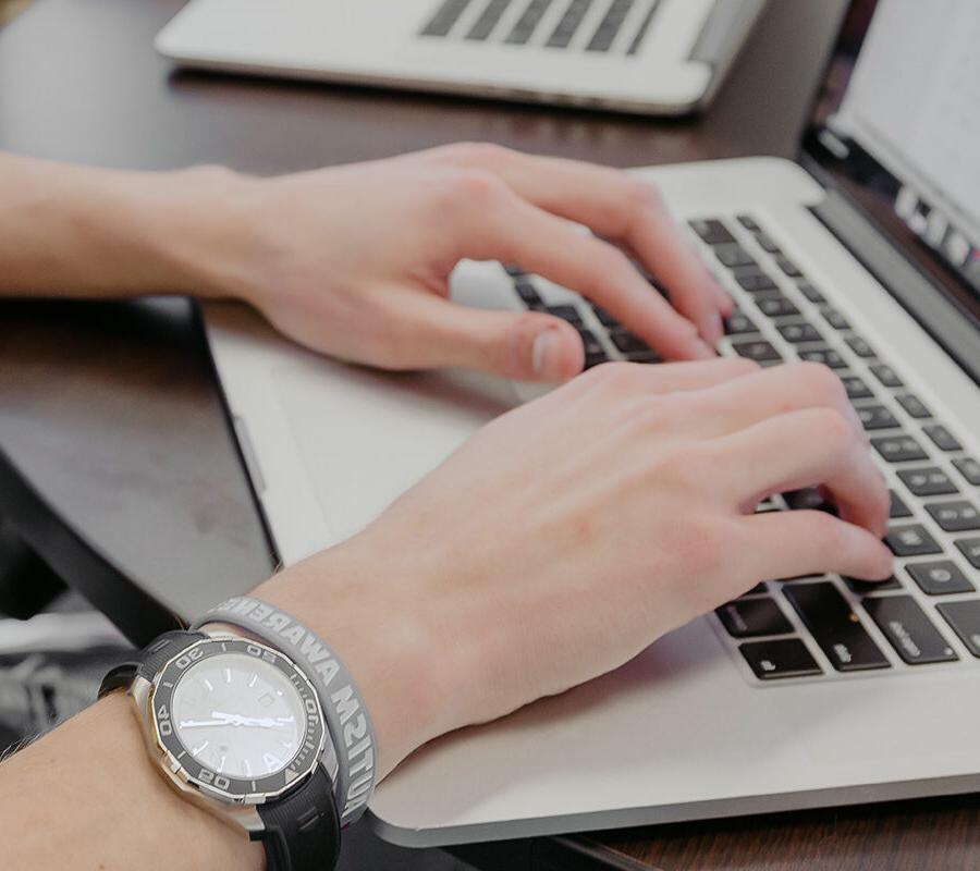 computer science student types on a keyboard.